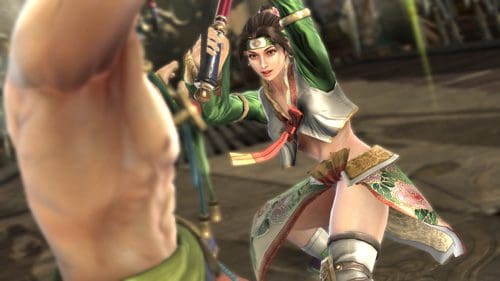 A female warrior in a colorful outfit, wielding a sword, is engaging in combat. She displays a fierce expression, showcasing agility in a traditional fighting arena backdrop. The scene emphasizes movement and intensity.