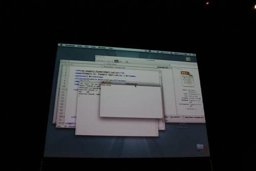 A computer screen displaying multiple overlapping windows, featuring lines of code in a programming editor. The interface shows a desktop background with icons and menus, illustrating a software development environment.