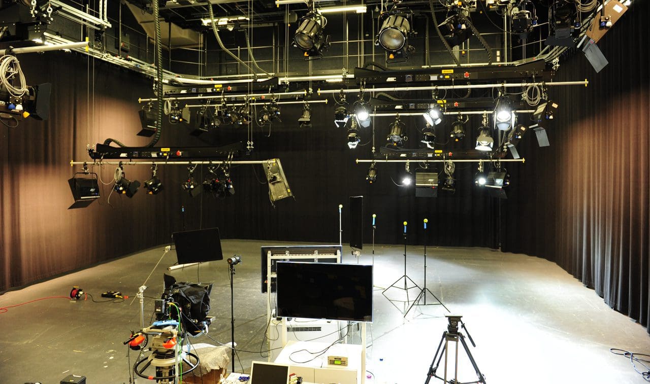 A TV studio setup with stage lights and equipment.