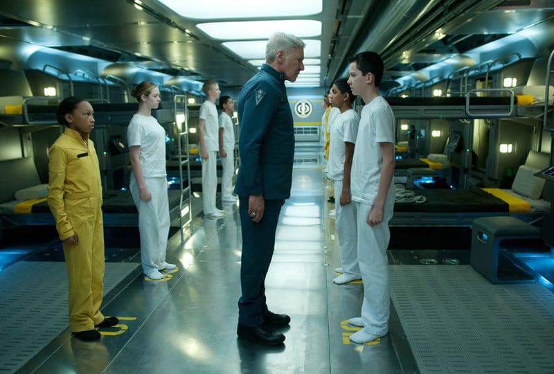 Adults and children standing in a futuristic setting