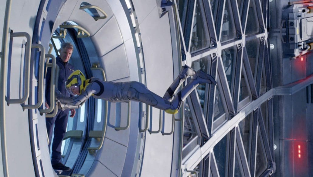 A humanoid robot extending towards a person in a spaceship interior.