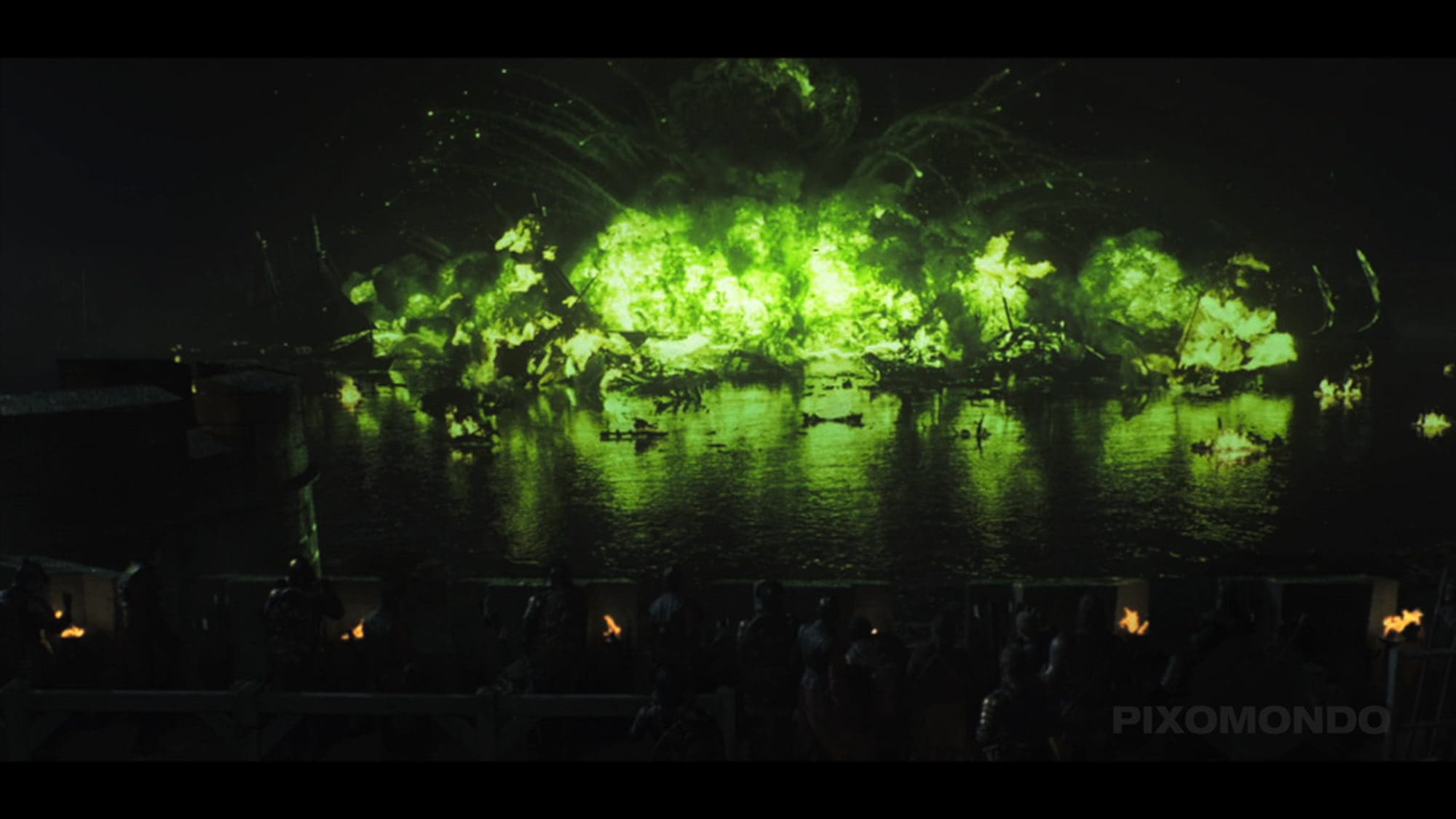 Green explosion reflected in water