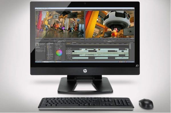 A computer with a large monitor showing video editing software and a keyboard and mouse in front.
