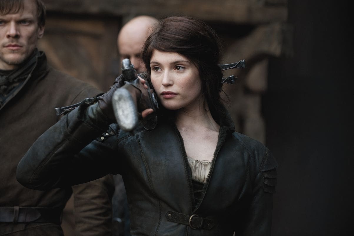 Woman holding a sword with two men behind her