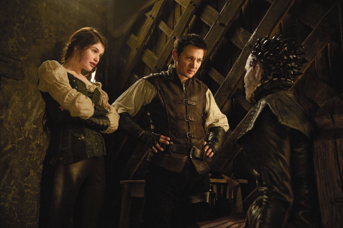 Two characters looking at a creature in a dimly lit setting.
