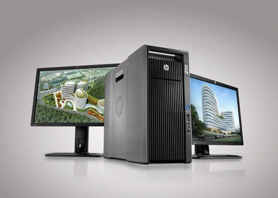 A desktop computer tower with two monitors displaying architectural designs.