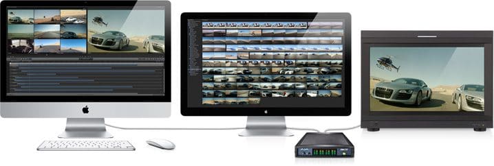 Three computer monitors displaying video editing interfaces.