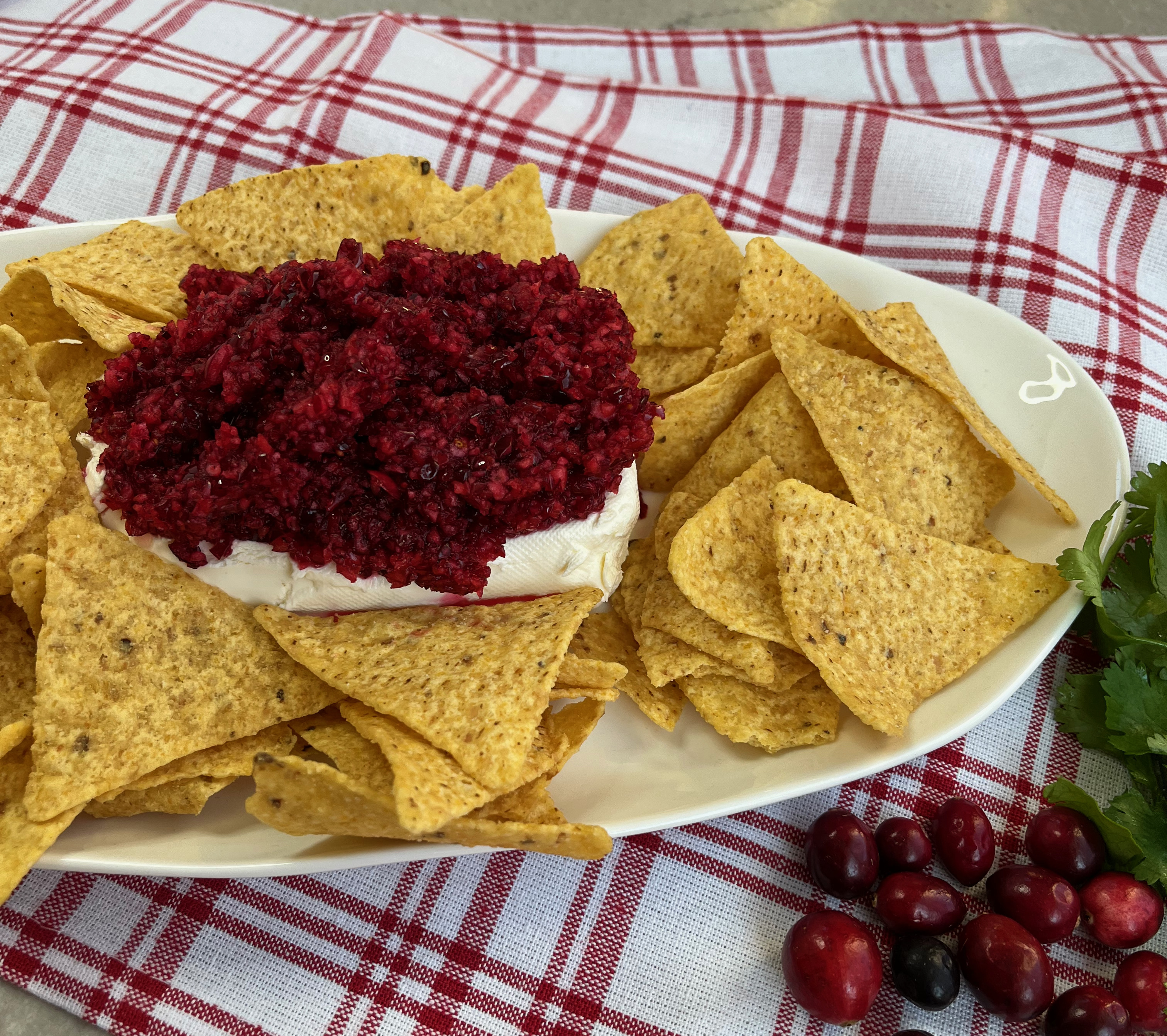 Cranberry with a touch of sugar mixed with a jalapeño and some cilantro served over cream cheese.