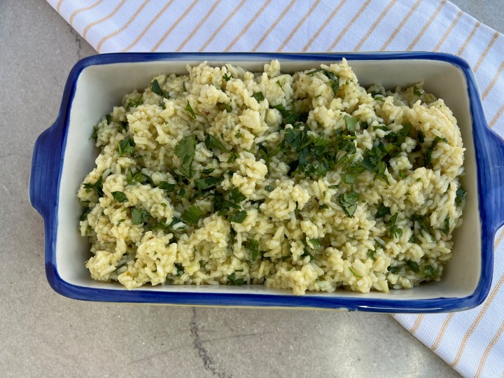 White rice cooked in chicken broth with dried onions and garlic powder. Bring to a boil, put the lid on and lower heat to simmer.  Cook for 20 minutes and add green enchilada sauce, lime juice and chopped cilantro.