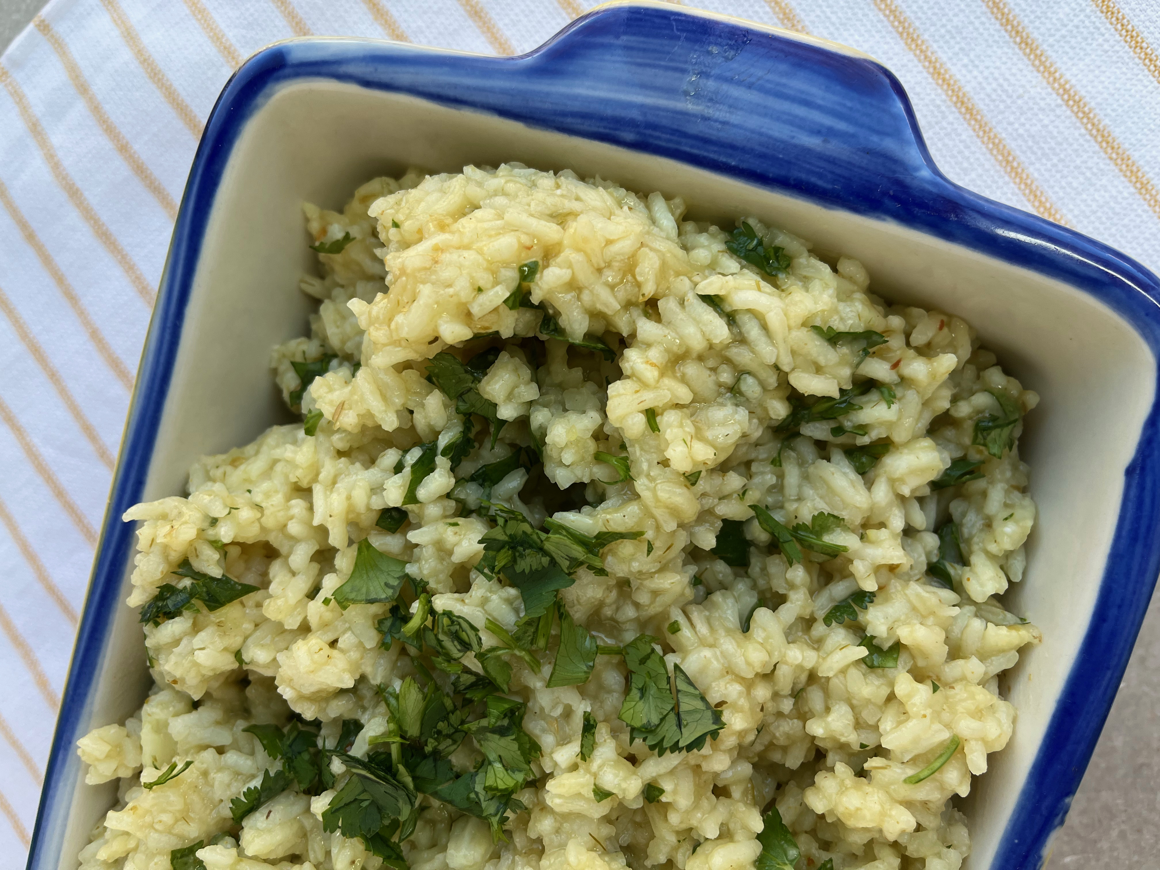 White rice cooked in chicken broth with dried onions and garlic powder. Bring to a boil, put the lid on and lower heat to simmer. Cook for 20 minutes and add green enchilada sauce, lime juice and chopped cilantro.