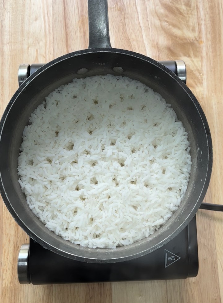 A picture of perfect rice.  Cook 2 cups of rice with 4 cups of water until boiling.  Put the lid turn the heat down and simmer for 20 minutes.