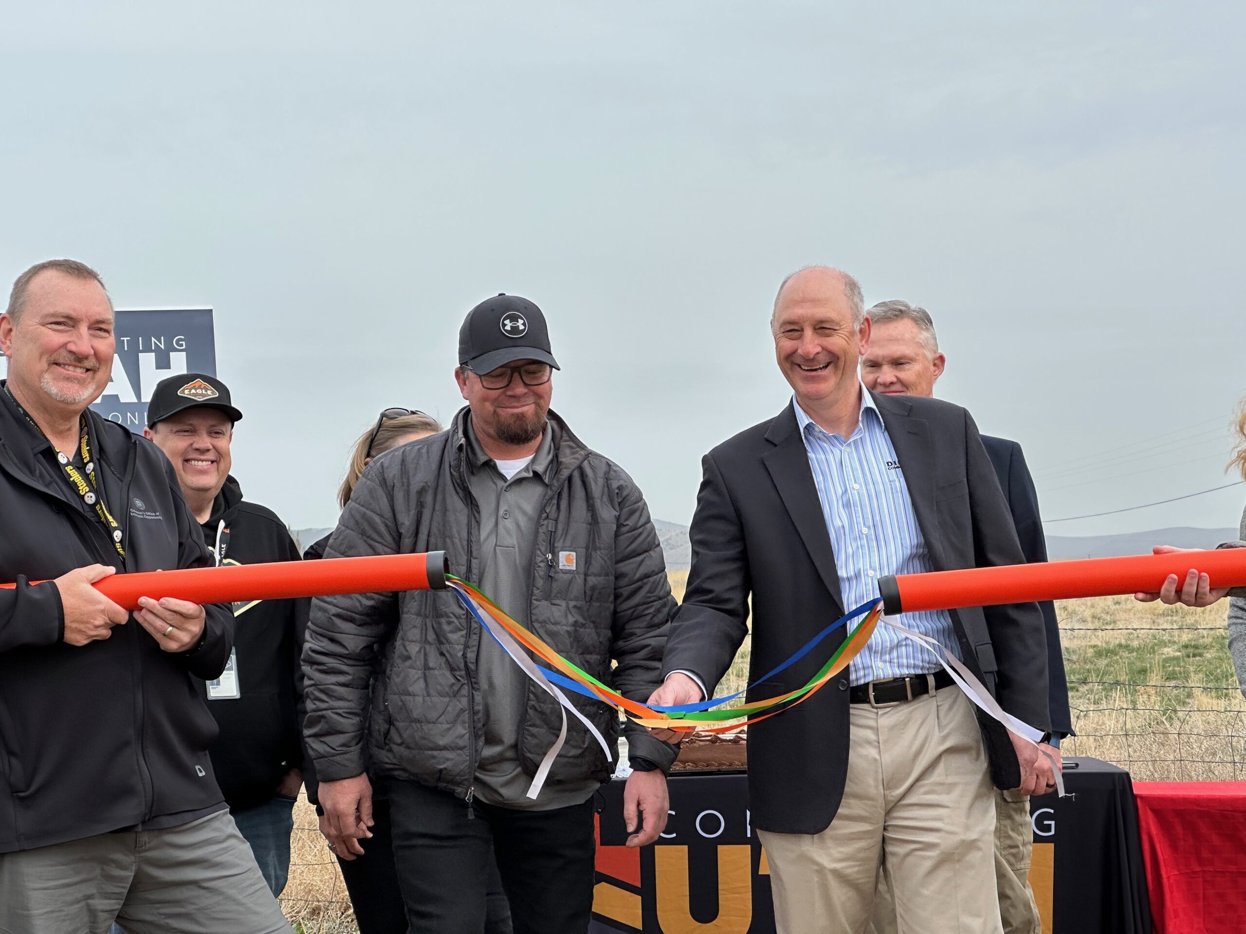 Participants hold the completed fiber ribbon splice, celebrating the successful expansion of Direct Communications’ fiber network.