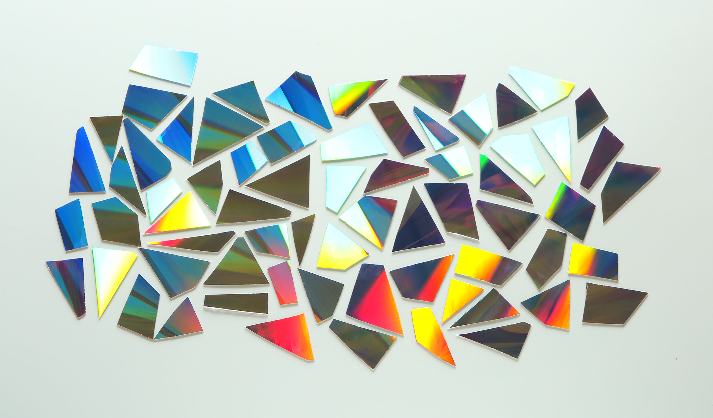 Shiny iridescent splinters on white background