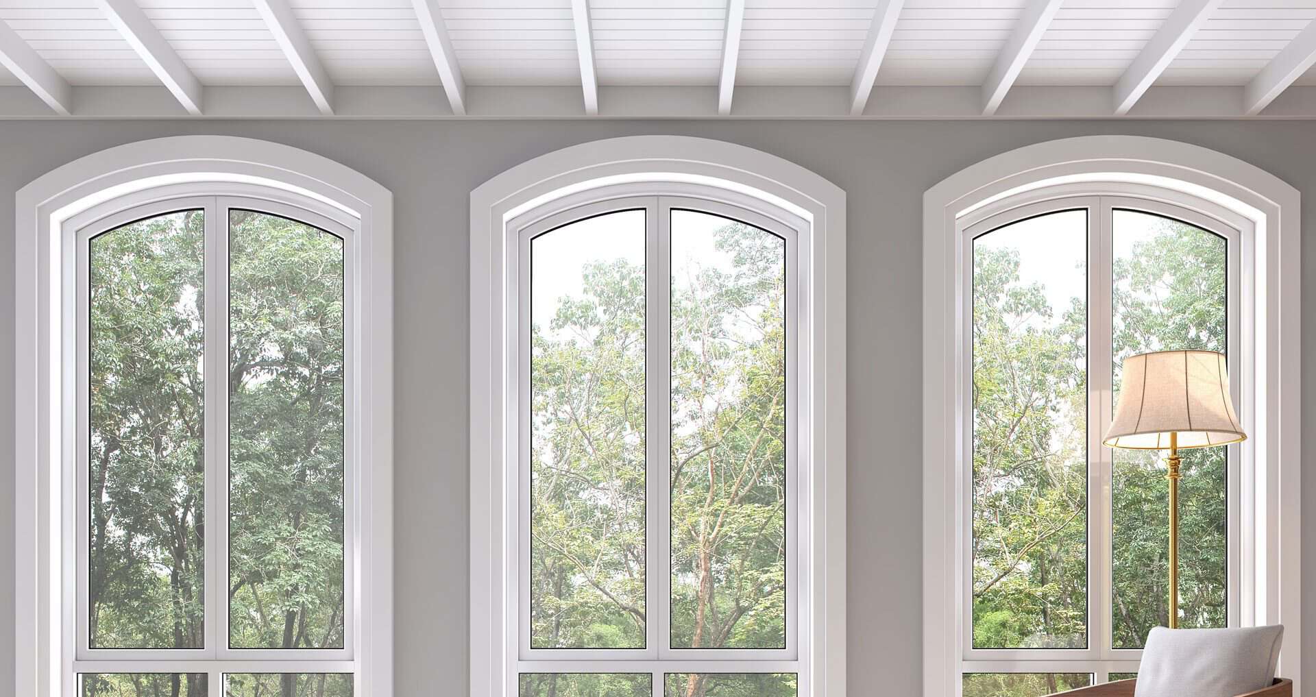 Aluminium windows with elegant arched design and large glass panes.