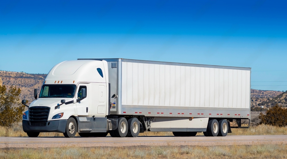 White dryvan truck driving