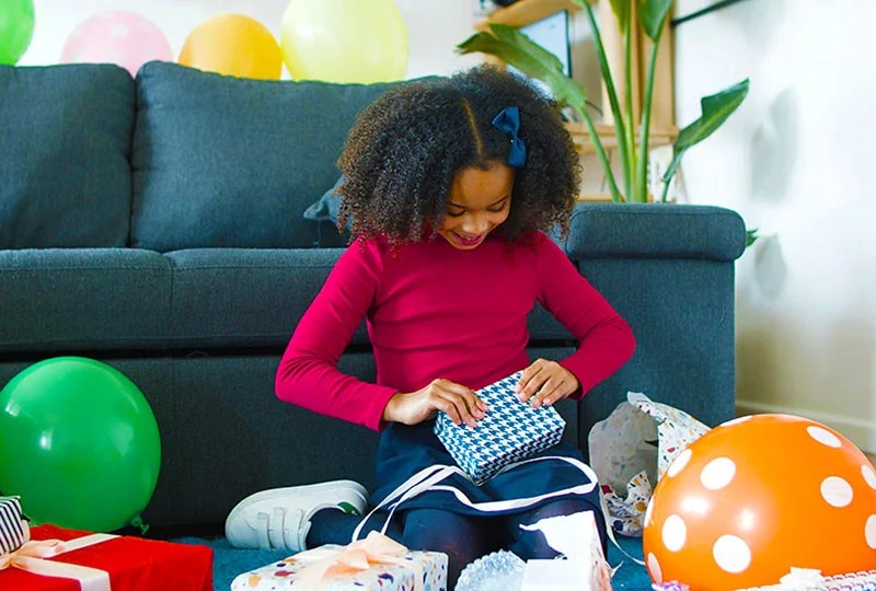 long distance presents - 14 year old girl opening present in living room