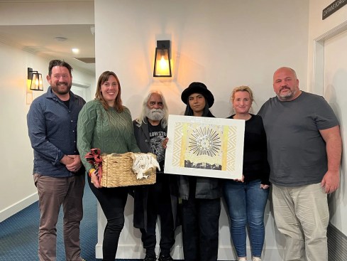 Exchange of gifts from Gunaikurnai Land and Water Aboriginal Corporation (GLaWAC) to Dja Dja Wurrung Group delegates at the Statewide Caring for Country Partnership Forum held on Gunaikurnai Country at Lakes Entrance. From left to right: Mark Costello, Katherine Mullet (GLaWAC), Uncle Tommy Baksh, Jessica Donaczy, Nicky McNamara, Daniel Miller (GLaWAC).