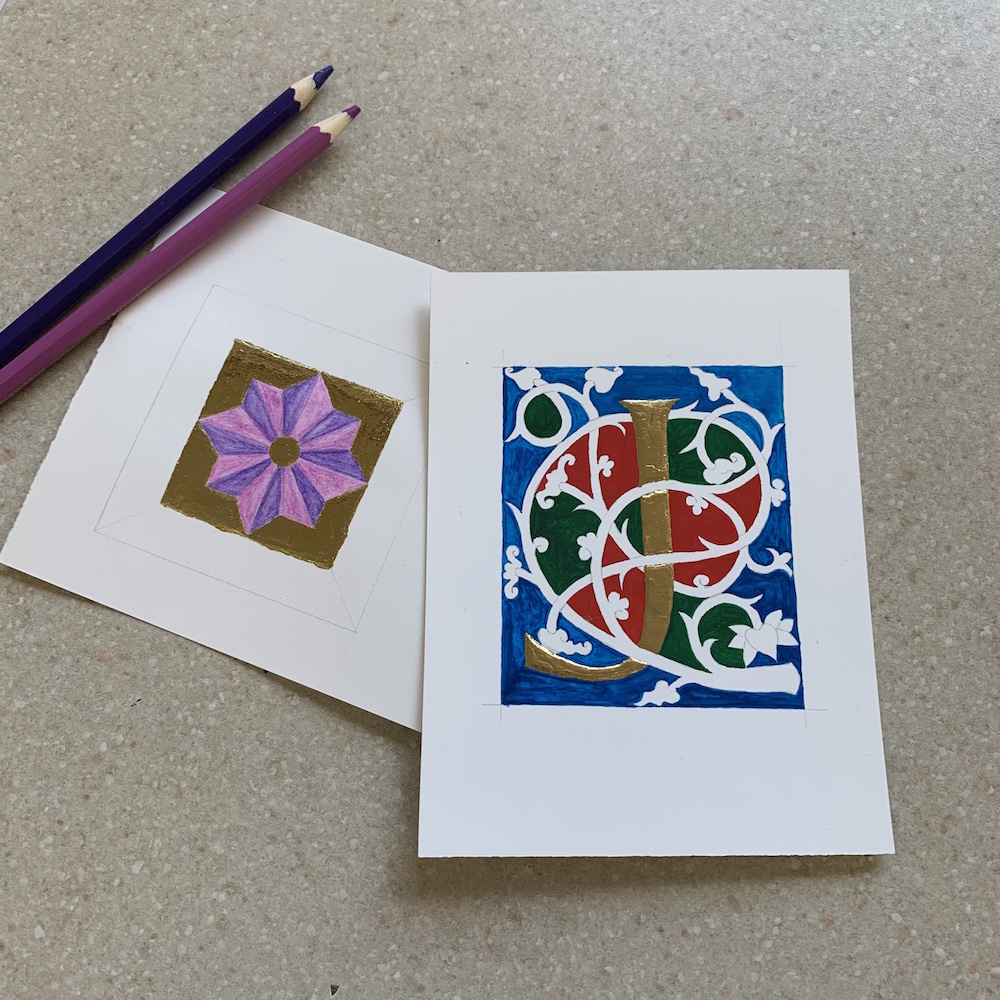 Gold leaf square and gold foil J in the process of being embellished.