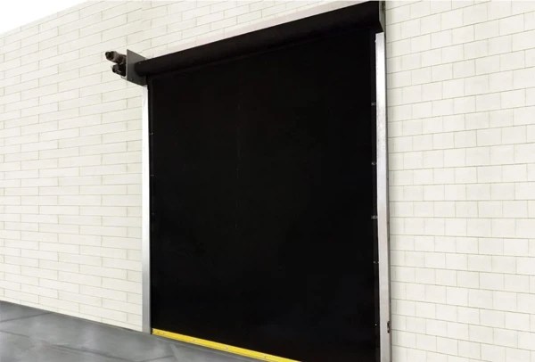 Black PowerTec™ Pro high-performance rubber door installed on a white brick wall.