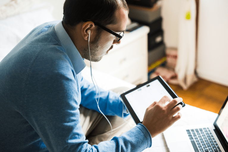 Man researches Interviews and Articles about Paul Kalanithi on his tablet.