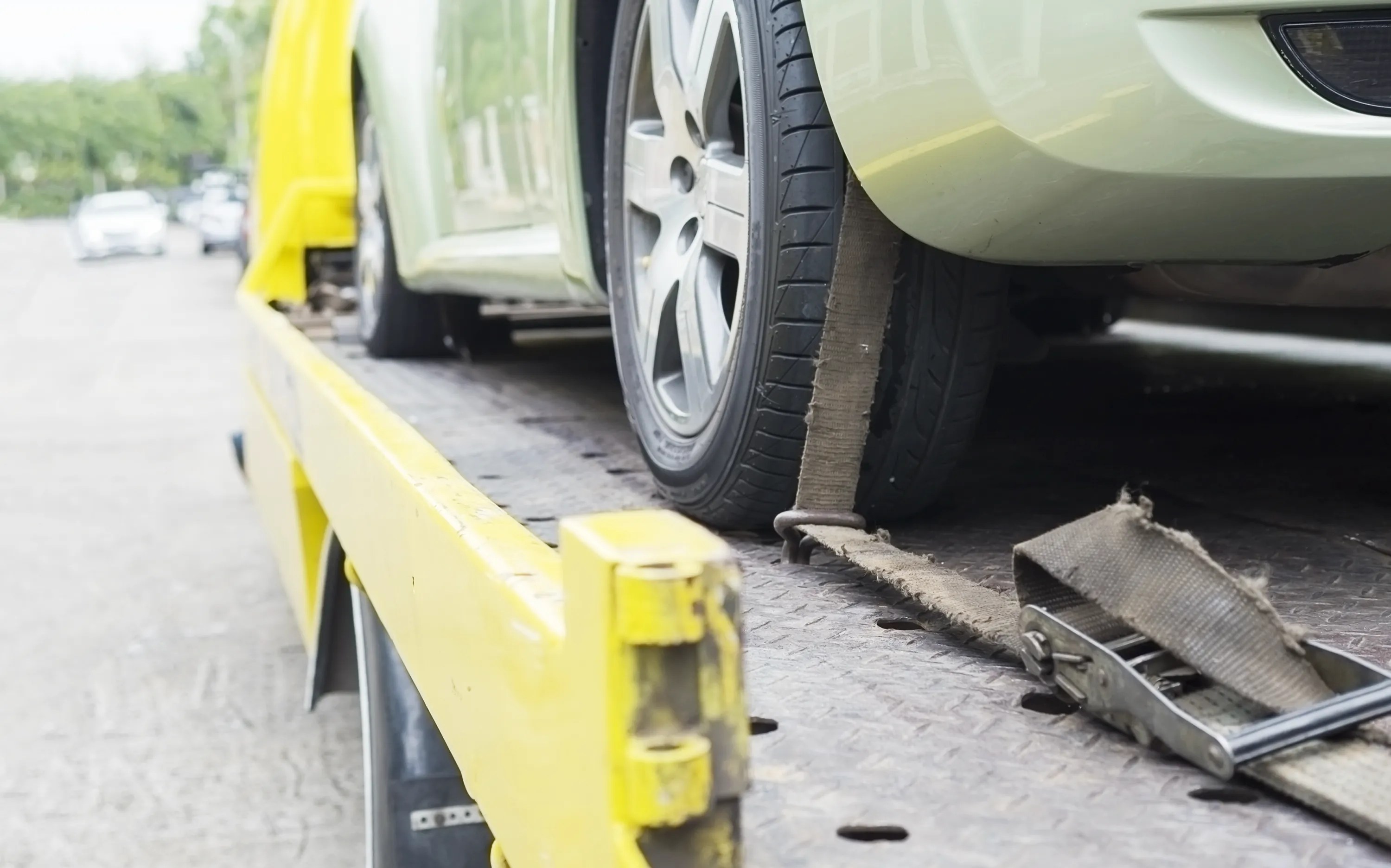 A car strapped to the deck of a vehicle transporter