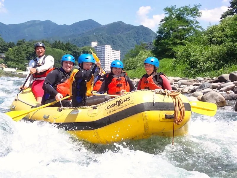 A group of tourists from overseas enjoy rafting through the river rapids of the Yubisogawa up in Minakami, Gunma Prefecture.
