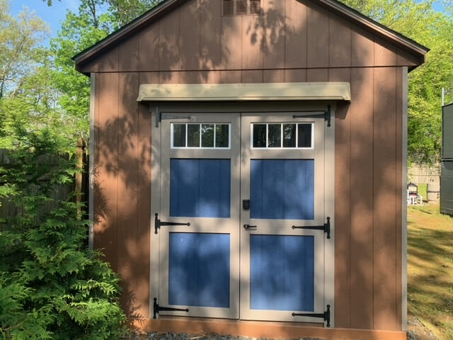 DOORBRIM rain diverter mounted above shed doors to stop a leak.