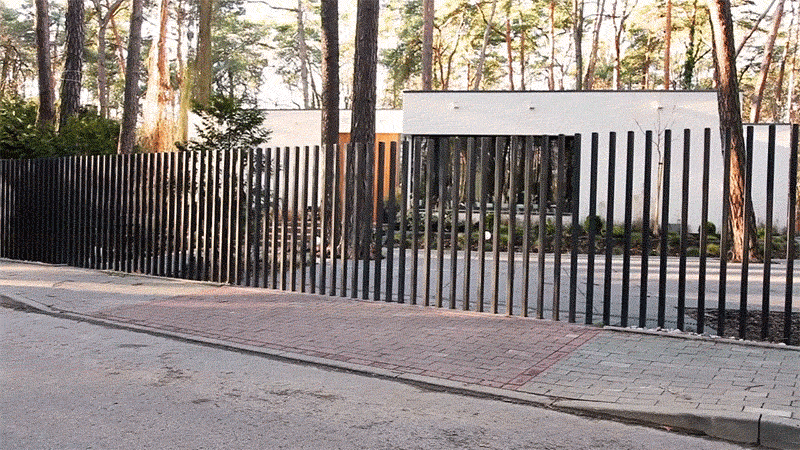 The retractable hose reel mounting post must be concreted into the ground but allows you to position the reel anywhere in the garden. Fancy Fences Feature Retractable Gates That Disappear Into the Ground | Designs & Ideas on Dornob