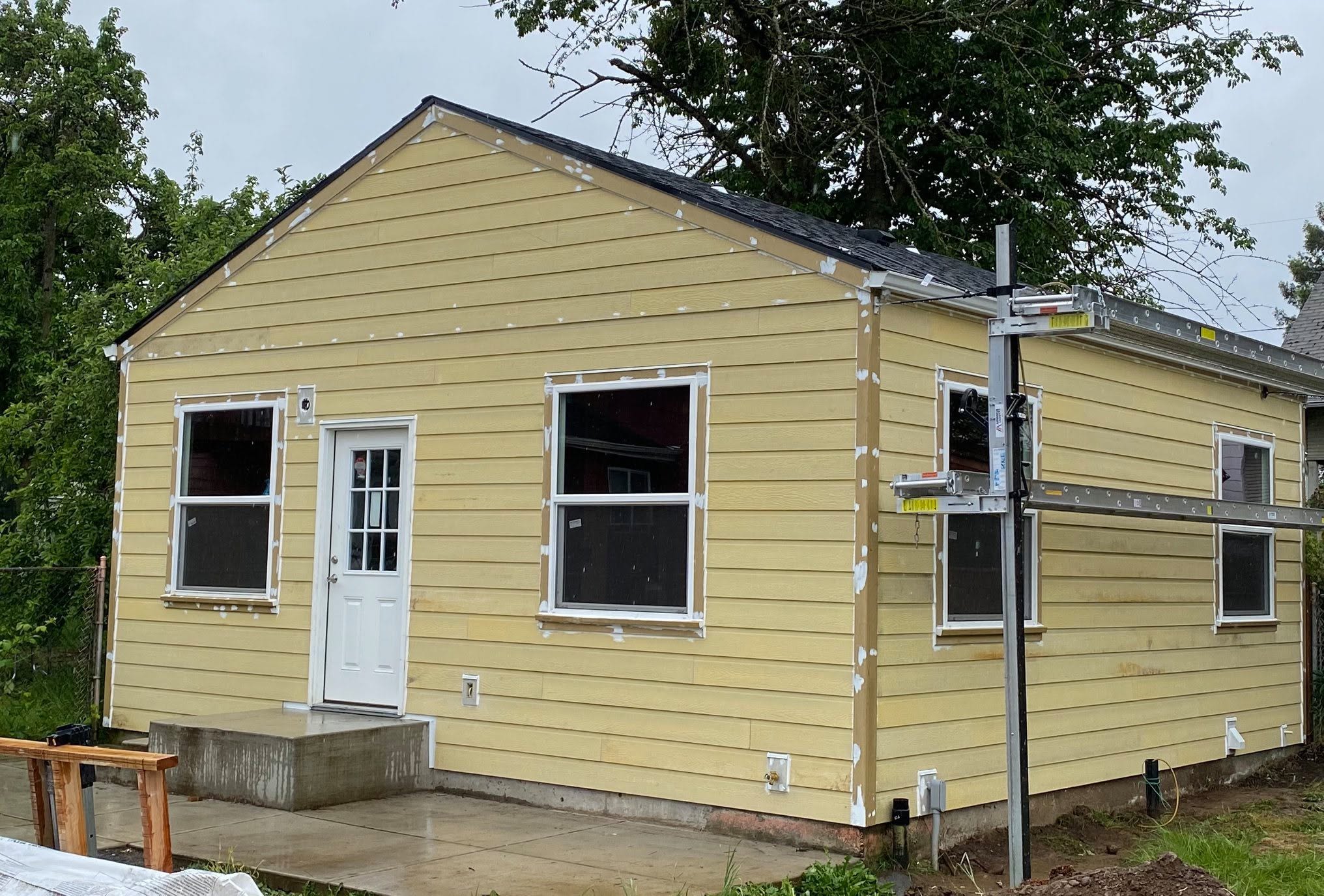 A yellow home under construction by Double P General Corporation