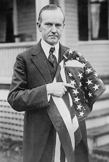 president calvin coolidge holding american flag