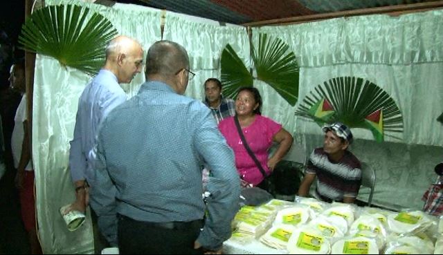 Minister of Communities Ronald Bulkan speaks with indigenous entrepreneurs at Essequibo Night 2016