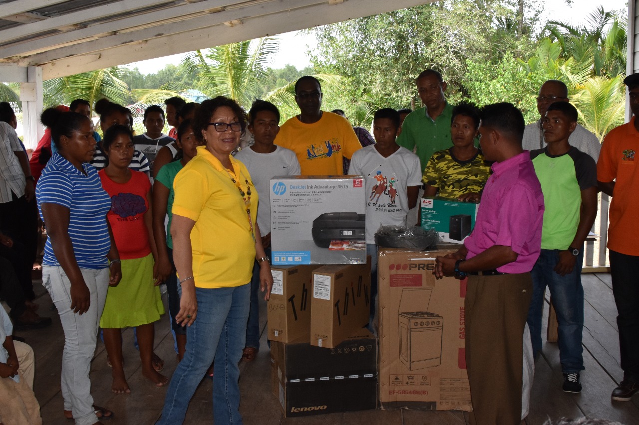 Minister within the Ministry of Indigenous Peoples’ Affairs Valerie Garrido-Lowe (left) presenting equipment to Toshao of Imbetero and HEYS participants