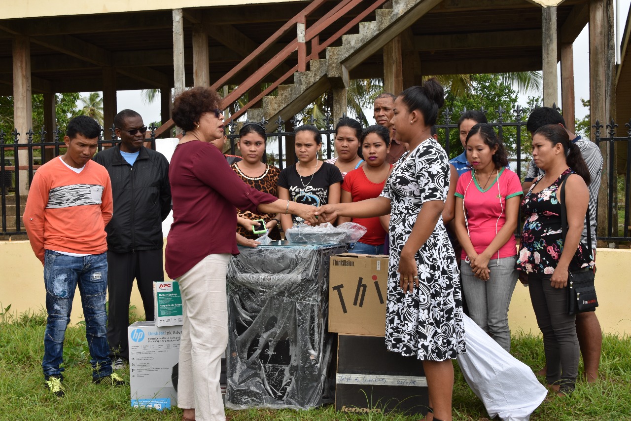 Minister within the Ministry of Indigenous Peoples’ Affairs Valerie Garrido-Lowe (left) handing over the equipment to HEYS participants of Hosororo