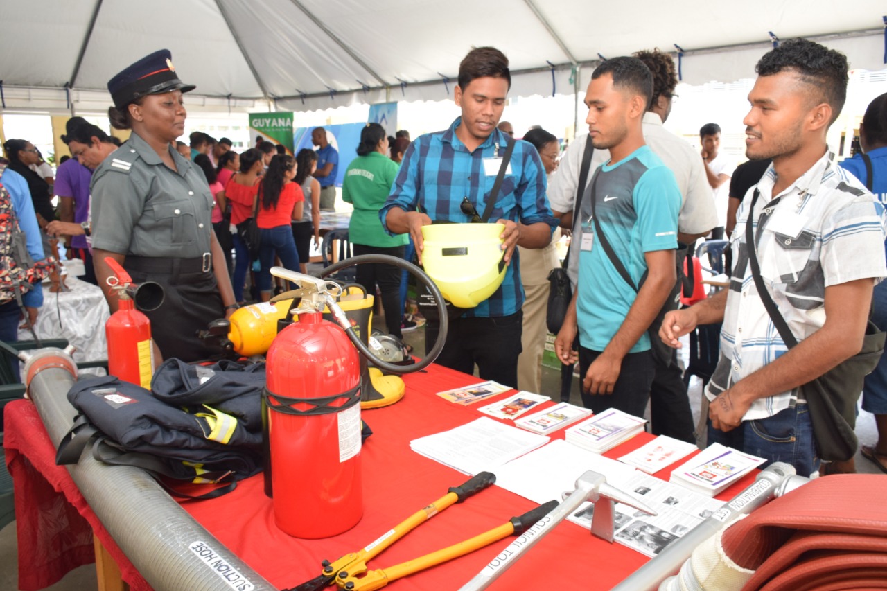 Participants examining one of the booths at the mini exhibition