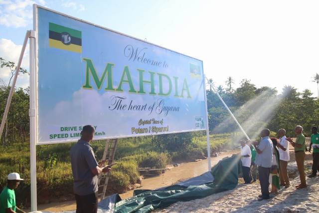 President Granger, Minster of State Joseph Harmon and Minister of Communities, Ronald Bulkan admire the sign board welcoming visitors to the town of Mahdia, after its unveiling.