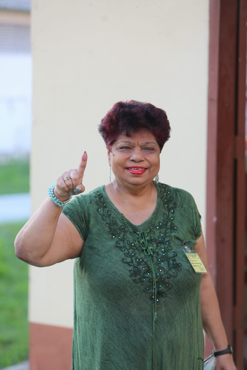 Minister of Social, Protection Amna Ally showing her inked finger after casting her vote