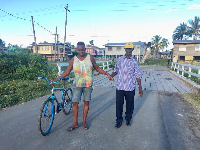 78-year-old Rudolph Innocent is being assisted as he makes his way to the Polling station.