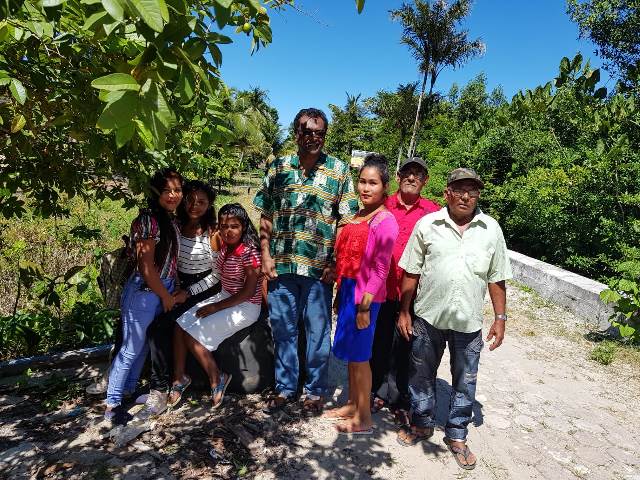 Minister of Public Security, Khemraj Ramjattan poses for a picture with residents of the community.
