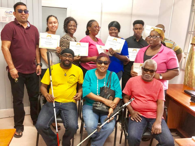 Rehabilitation and Habilitation Specialist, Molesimi Kono and a batch of his visually impaired graduates.