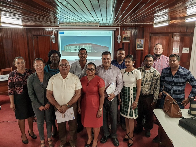 Team and the approved two-storey design in the background.