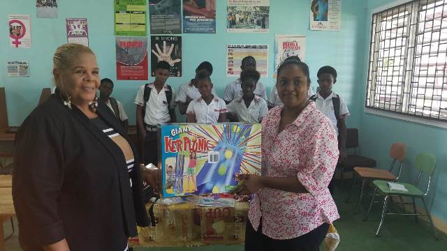 Donations made by Roxanne Persaud, Guyanese-American politician and presented by Secretary of the board [right] Linda Enmore and Namela Henry Chairman of the board [left] of the 'Mystique Dance and Youth Empowerment'.