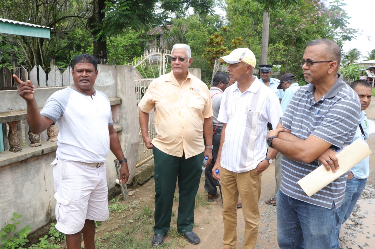 Ministers Holder and Bulkan and Nizam Hassan listen as a resident make a pointMinisters Holder and Bulkan and Nizam Hassan listen as a resident make a point