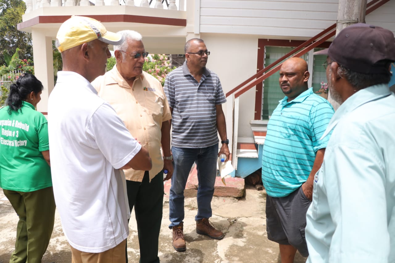 Ministers Holder and Bulklan engage another resident at his home