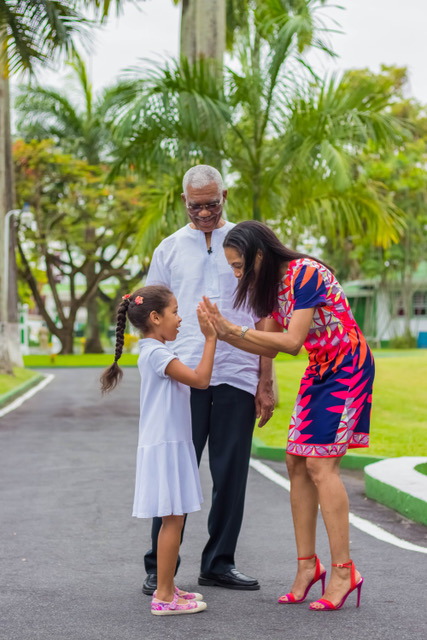 President David Granger admires his daughter, Mrs. Han Granger- Gaskin and granddaughter Faraa Gaskin as they play a game at State House, Georgetown.
