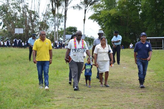 Minister Winston Felix is accompanied by representatives of Kartabo during his visit to the Region Seven community.
