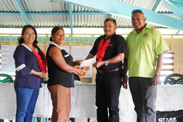 Minister of Indigenous Peoples’ Affairs, Sydney Allicock hands over the cheque to Toshao of Baramita, Sharmine Rambajue in the presence of Minister of State, Dawn Hastings-Williams, and Special Assistant on Projects and Community Development to the Ministry of Indigenous Peoples' Affairs, Martin Cheong.