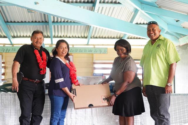 Minister of State, Dawn Hastings-Williams hands over the computer to a teacher of the Baramita Primary School in the presence of Minister of Indigenous Peoples’ Affairs, Sydney Allicock and Special Assistance on Projects and Community Development to the Ministry of Indigenous Peoples' Affairs, Martin Cheong.