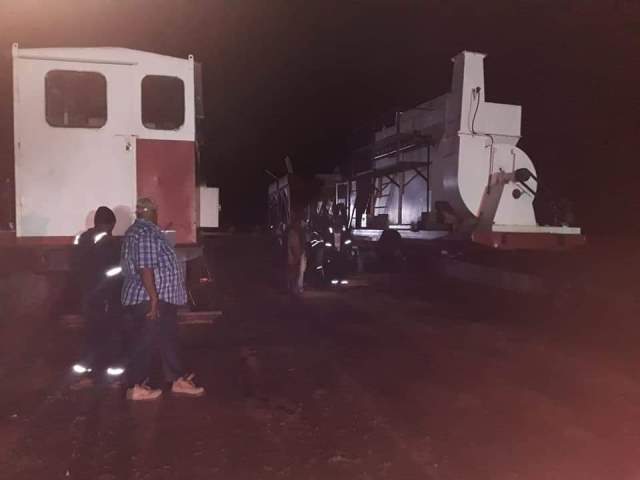 Mobile asphalt plant being loaded onto a barge en route to Wakenaam.