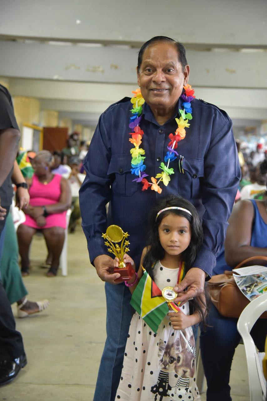 Prime Minister, Moses Nagamootoo and little Aria Ali of Victoria North Nursery School, who won the award for the best-behaved student.