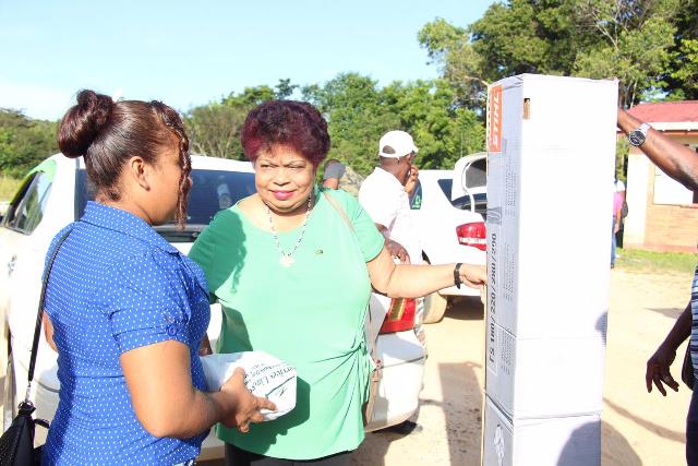 Minister of Social protection, Hon. Amna Ally donates brush cutter to residents of Santa Rosa.